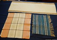 All three woven mats displayed on dark surface