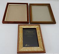 Three wood picture frames laid out front view