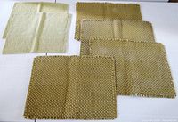 All six woven green placemats arranged on table, showing colors, textures, and condition