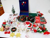 Overview of entire lot showing boxed Santa Lites, tea towels, wreaths and assorted ornaments