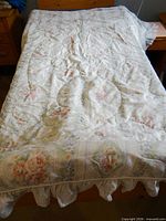 Full view of comforter on twin bed showing overall pattern and ruffle