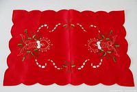 Full view of red embroidered Christmas table mat
