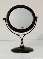 Front view showing circular mirror and base