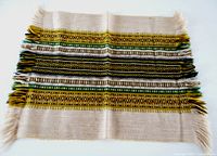 full view of table mat front showing overall design and fringe