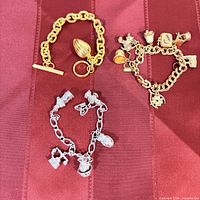 Overall view of three metal bracelets on fabric background