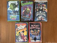 Front covers of all five VHS tapes arranged on table