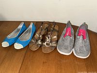 All three pairs of shoes displayed side by side on table