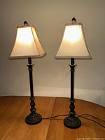 Full view of both matching table lamps on surface
