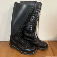 Front and side view of both boots showing height, lacing, leather, and soles