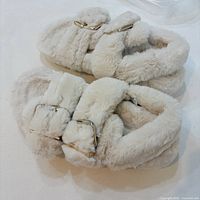 Top view of the plush faux-fur slippers showing straps and buckles
