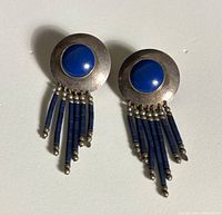 Front view showing both earrings, blue cabochons and bead fringe
