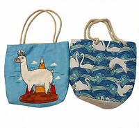 Front view of both tote bags showing llama graphic and swan pattern