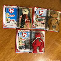 Front view of three packaged Teenie Beanie bears: Spangle, Germania, Osito
