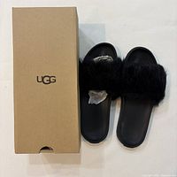 Sandals beside original UGG box, top view