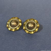 Front view of both round scalloped silver earrings