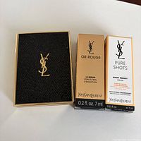 Front view of eyeshadow compact and two boxed serums