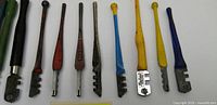 Lineup of 10 of the 11 glass cutters showing varied handle colours and head styles