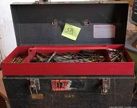 Closed black toolbox with lid open showing red tray of drill bits