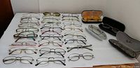 Overhead view of all 30 eyeglasses and 4 cases
