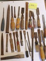 Group of chisels laid out with handles and blades visible