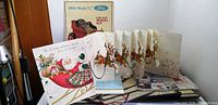 Front view of lot showing Ford model kit box, Hallmark Christmas card, folded world map leaflet and assorted papers