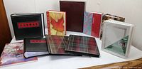 Group shot of all ten photo albums displaying varied covers