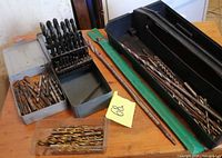 overall view of tool box, drill bits in multiple containers on table
