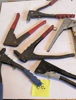 Group of five rivet guns showing handle colors and styles