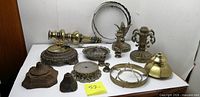 All lamp parts laid out showing variety of bases, spacers, column and rings