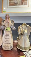 Both angel figurines side by side on table