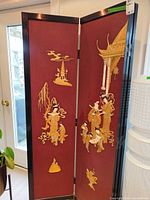 Full view of two panels showing carved figures and pagoda detail