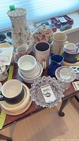 All items on tabletop showing vase, teapot, mugs, ramekins, ashtray