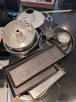 Stacked bakeware showing tube pans, ceramic dish and tart pans