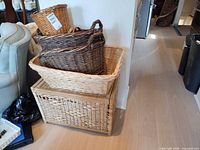 Stack of three baskets on top of wicker storage box