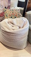 Bean bag chair front with pillow behind