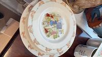 Two stacked Royal Doulton Bunnykins plates showing rim with rabbit border and central classroom scene