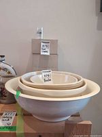 Nested set of four ceramic bowls on a stool