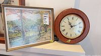 Clock and artwork on shelf