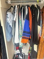 Full rail of assorted garments on hangers