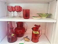 Top shelf with stem glasses, drinking glasses, single tumbler, small leaf bowl