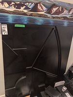 Full view of one black geometric relief wooden panel