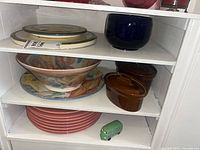 Three shelves showing all ceramic and glass items