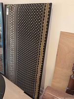 Full view of upholstered headboard standing upright