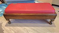 Full view of footstool showing frame, cushion and legs