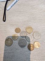 All ten Hungarian forint coins laid out showing denomination mix