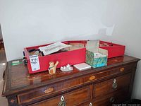 Overall lot with table hockey kit on dresser, bird whistle and miniature tea set visible