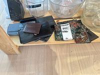 Group of wallets and coin purses on shelf