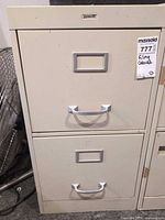 Front view of filing cabinet showing both drawers, handles, label holders and lock