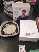 Headband in open case beside retail boxes