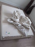 Full mattress with cover folded back showing surface